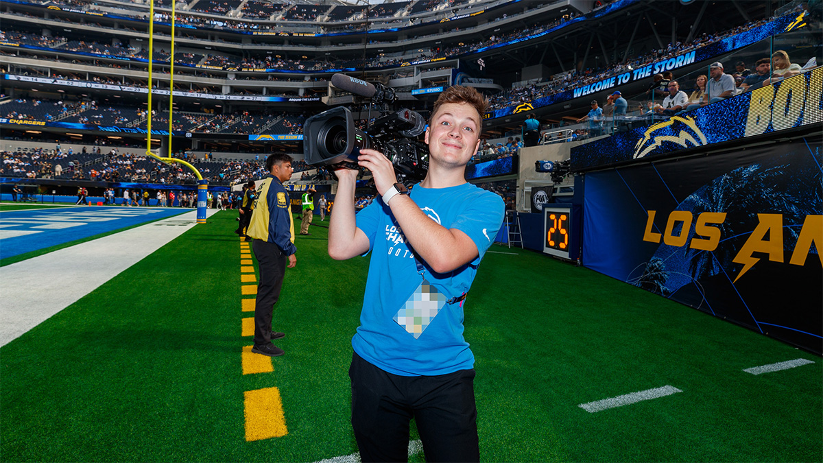 Bailey in SoFi Stadium holding up a camera