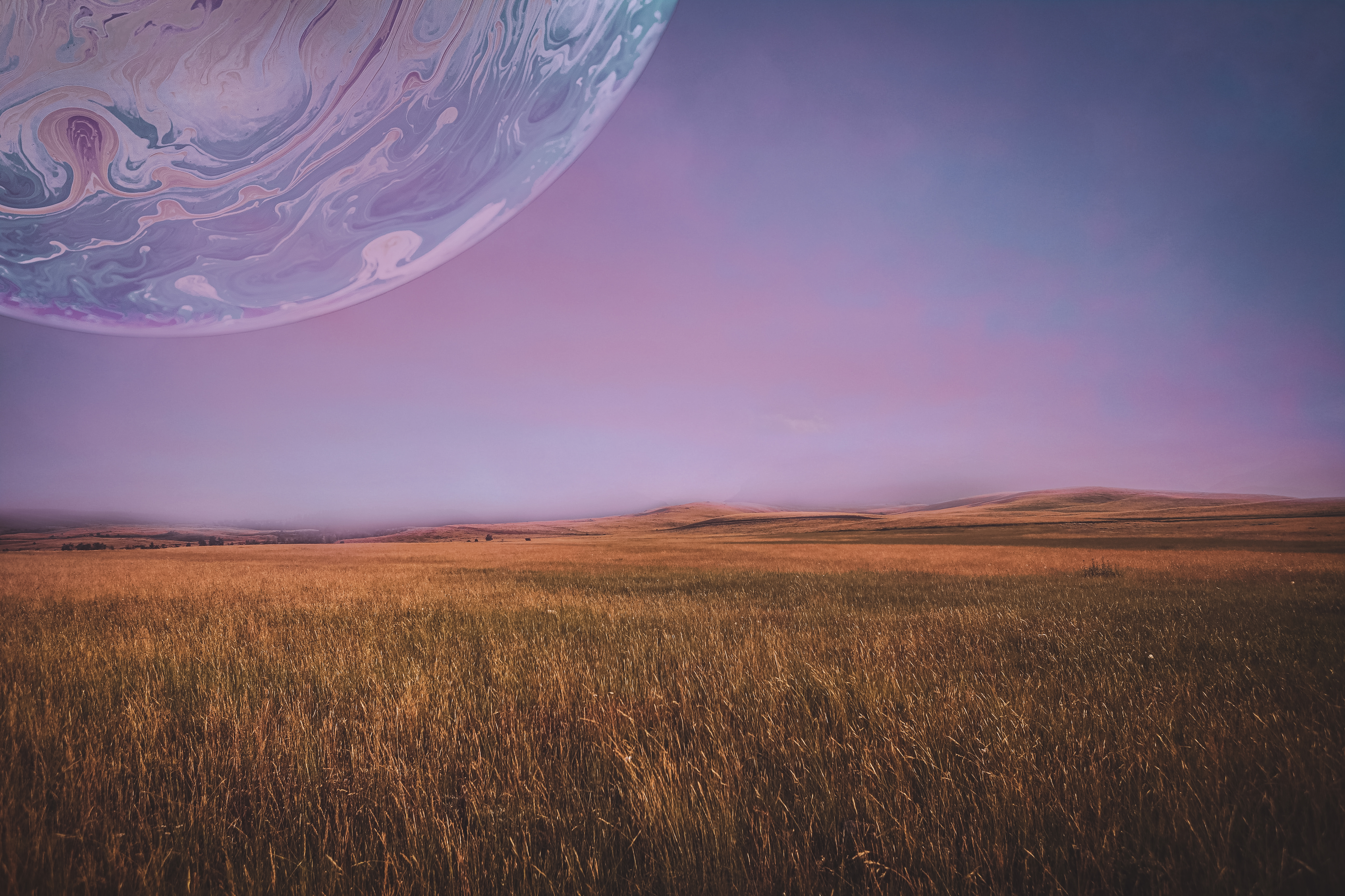 A majestic landscape of grasslands with a big moon in the sky that looks like a gas giant